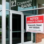 A "Closed" sign on a glass door of a major Indian bank with a calendar marked for April 13 and 14.